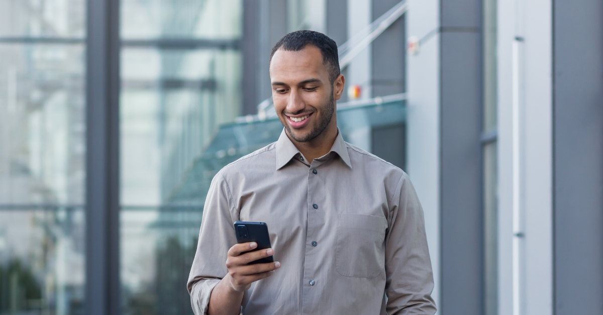 man standing outside building on phone